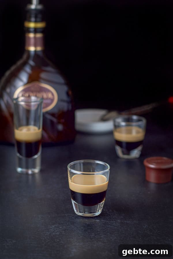 chocolate liqueur layered in the three glasses with the bottle in the background