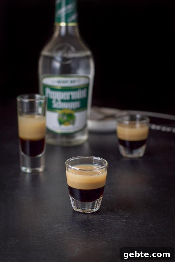 peppermint schnapps layered in with the bottle and spoons in the background