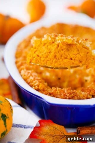 scooping a large spoonful go pumpkin gratin
