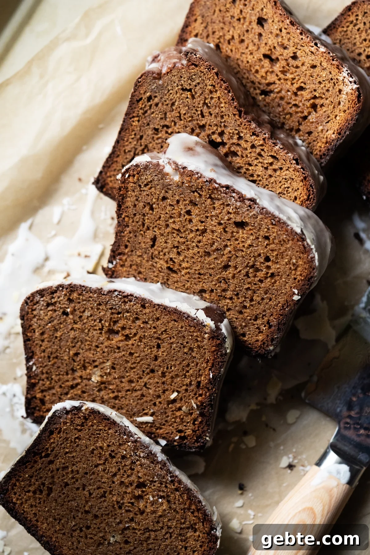 Sliced and freshly glazed low carb gingerbread loaf showing the fluffy texture