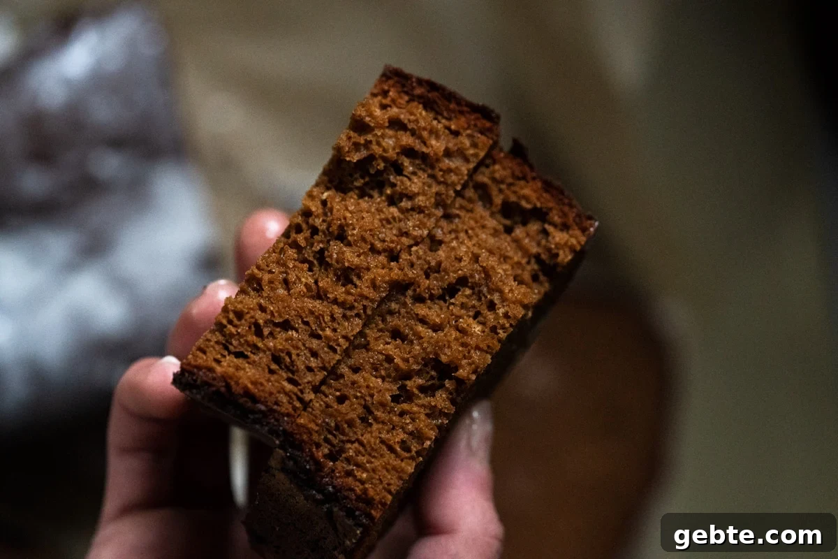 A closeup of a halved gingerbread slice showing the moist, fluffy and crumb like texture