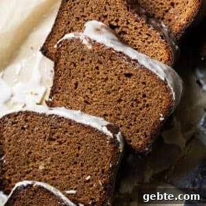 Sliced and freshly glazed low carb gingerbread loaf showing the fluffy texture