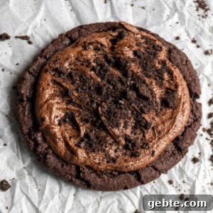 Copycat Crumbl Dirt Cake Cookie Recipe — Soft Chocolate Cake Cookies 6 Close up of a dirt cake crumbl cookie copycat recipe on parchment paper.