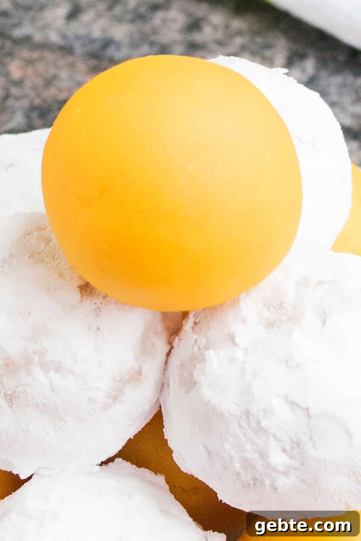 Lemon Cake Truffles: Zesty Bite-Sized Dessert Recipe 11 Tower of Lemon Cake Balls With Some Coated in Powdered Sugar.