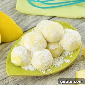 Lemon Cake Truffles: Zesty Bite-Sized Dessert Recipe 9 Candy balls coated in powdered sugar on green dish.