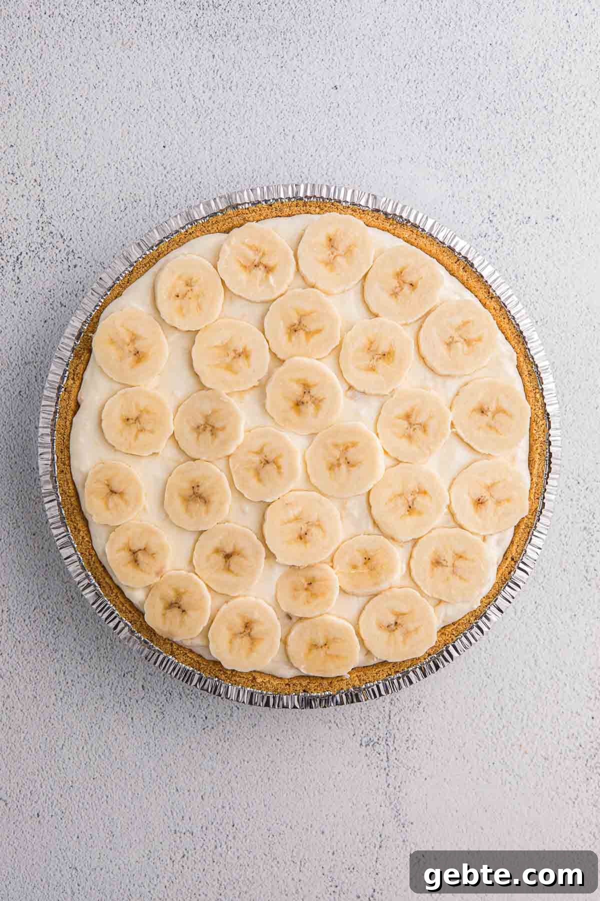 Banana slices layered over creamy filling in a graham cracker crust.