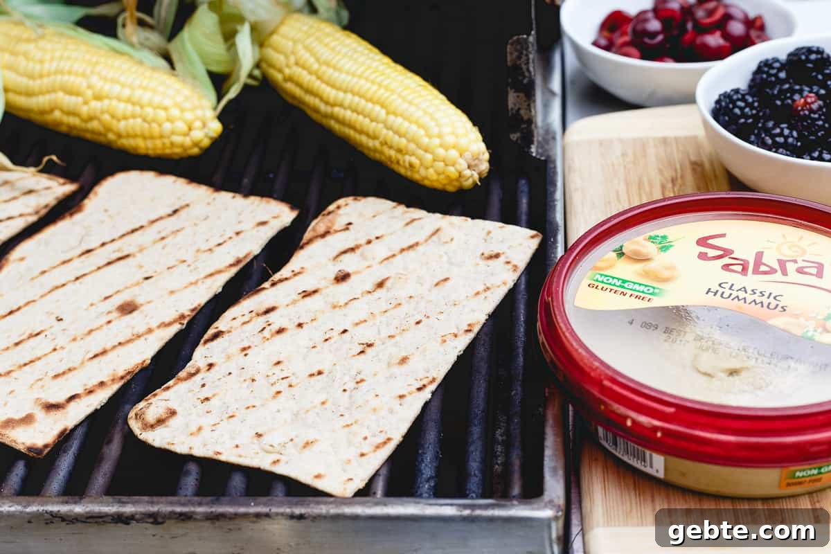 Grilled corn, berries, fresh cherries and hummus make a delicious flatbread for summer dining. Grilled corn, berries, fresh cherries and hummus make a delicious flatbread for summer dining.