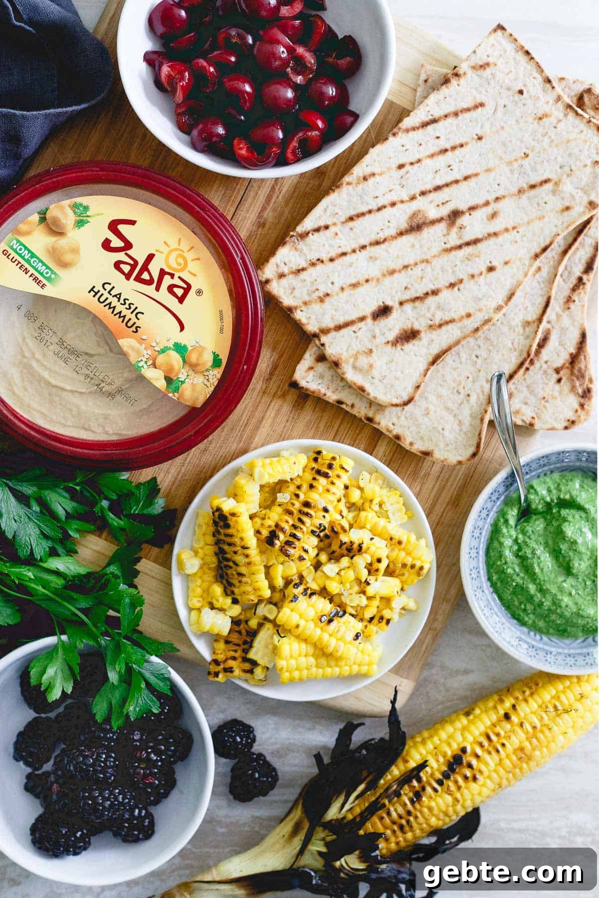 These grilled hummus flatbreads topped with berries, cherries and corn are the perfect summer snack before dinner! These grilled hummus flatbreads topped with berries, cherries and corn are the perfect summer snack before dinner!