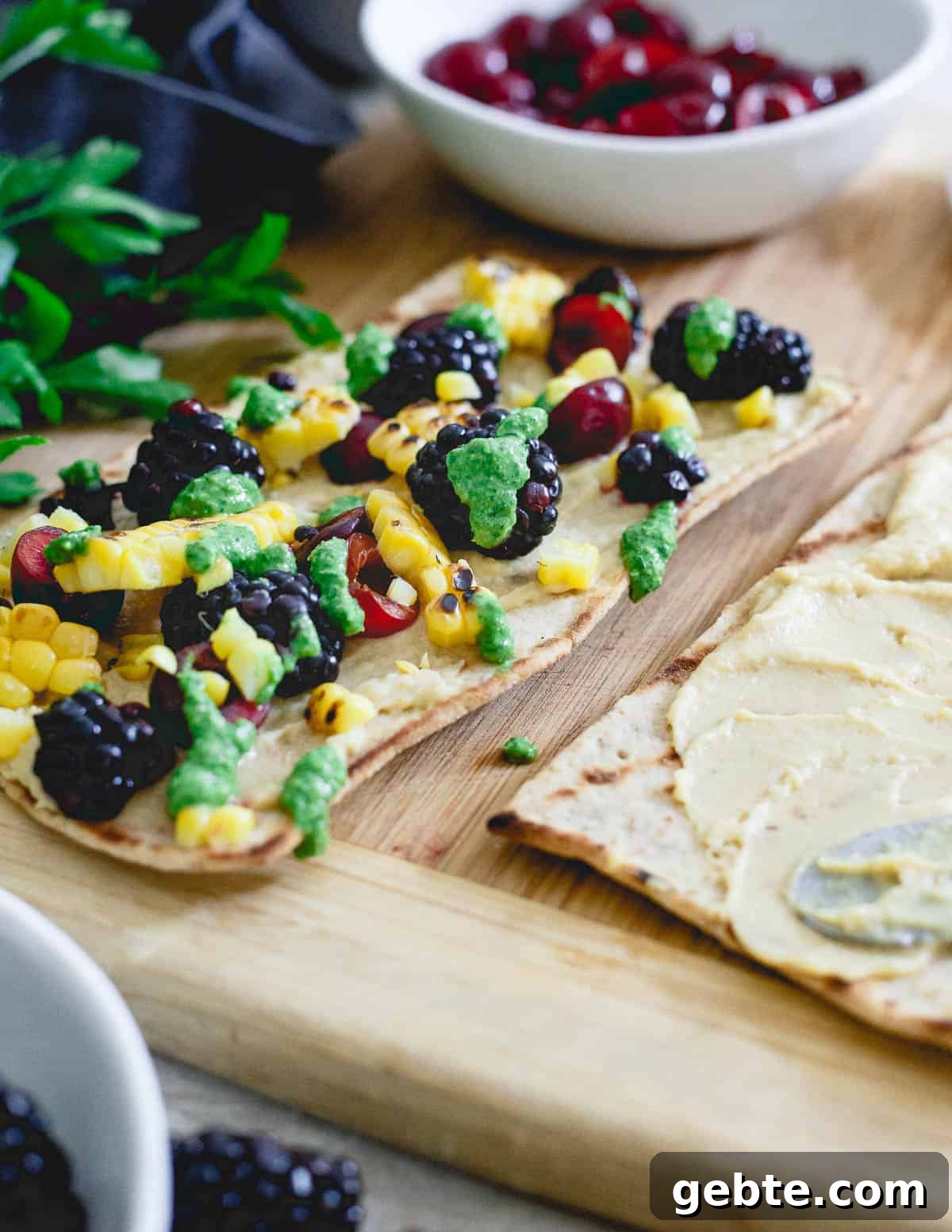 Topped with a fresh parsley pesto, these grilled hummus flatbreads are the perfect unofficial meal for snacking before dinnertime! Topped with a fresh parsley pesto, these grilled hummus flatbreads are the perfect unofficial meal for snacking before dinnertime!