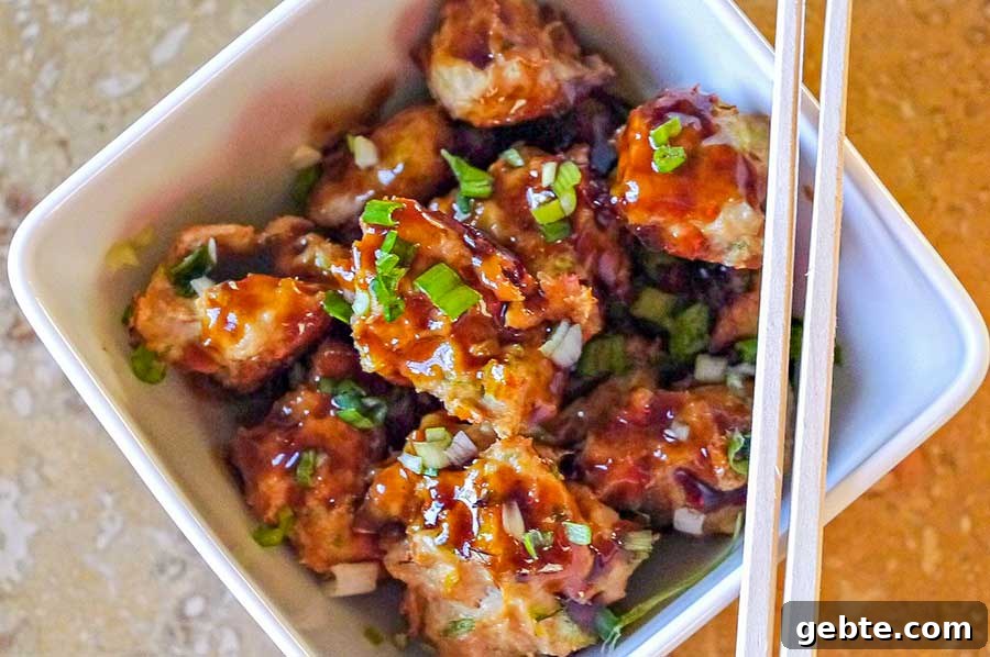 asian meatballs in a bowl with chopsticks