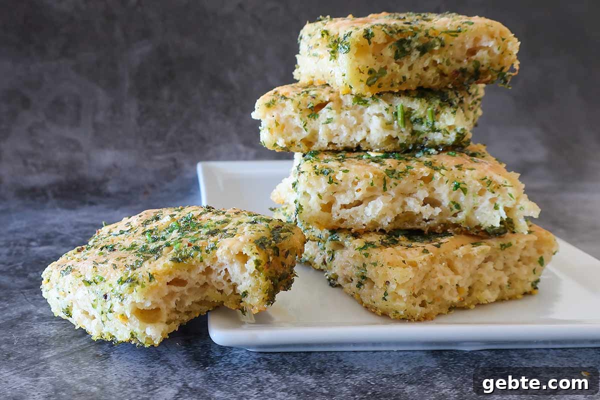 stacked gluten free tear and share pieces of garlic bread on a plate