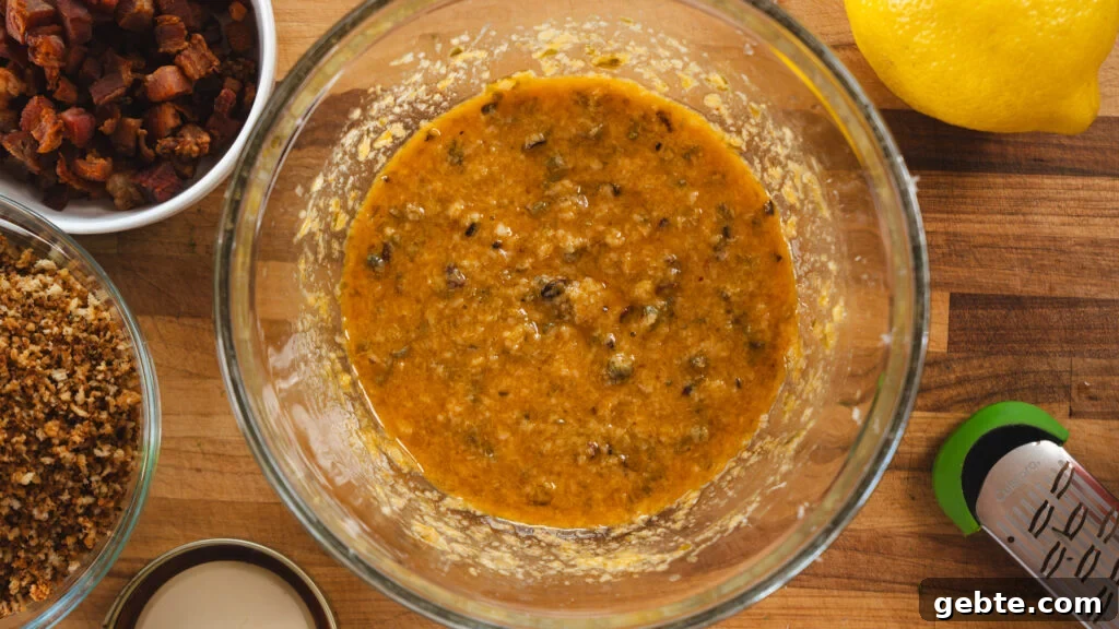 Viral Kale Caesar Salad for Quick Weeknight Dinners 5 Kale caesar salad dressing being made in a bowl.