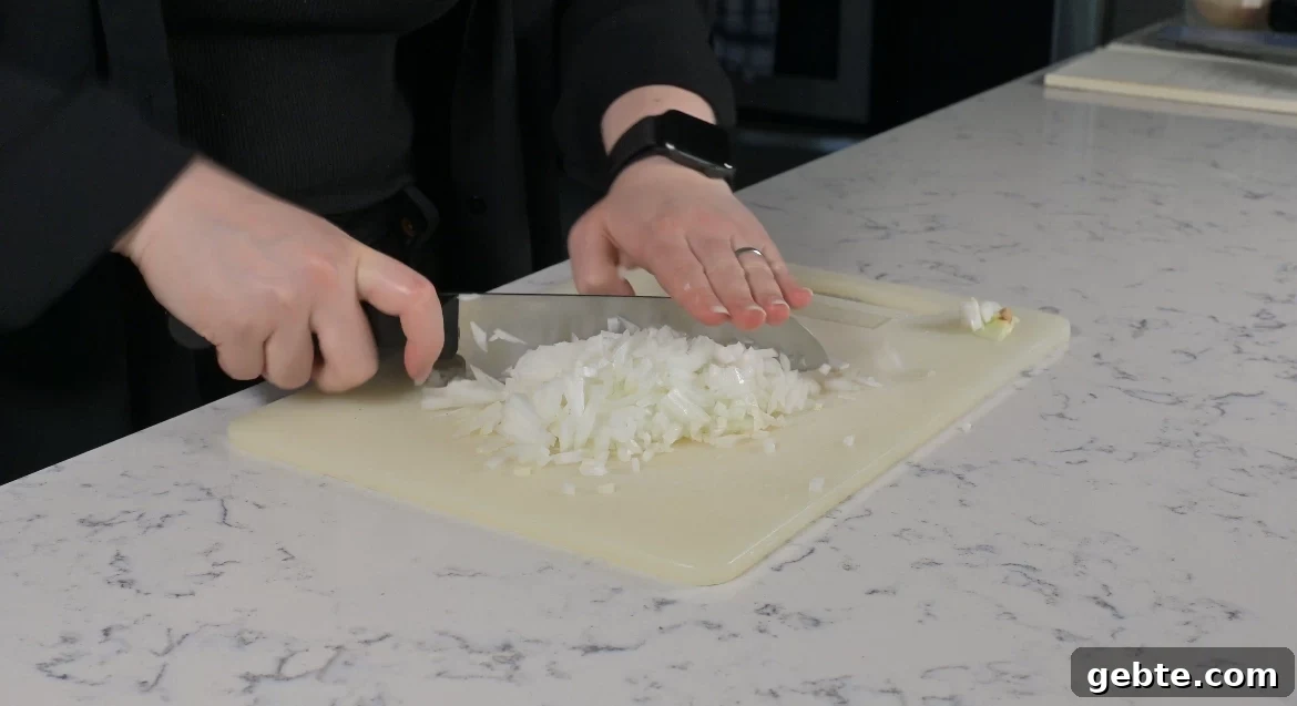 Authentic Swedish Köttbullar Recipe: Classic Meatballs with Creamy Gravy 11 Chopping an onion.