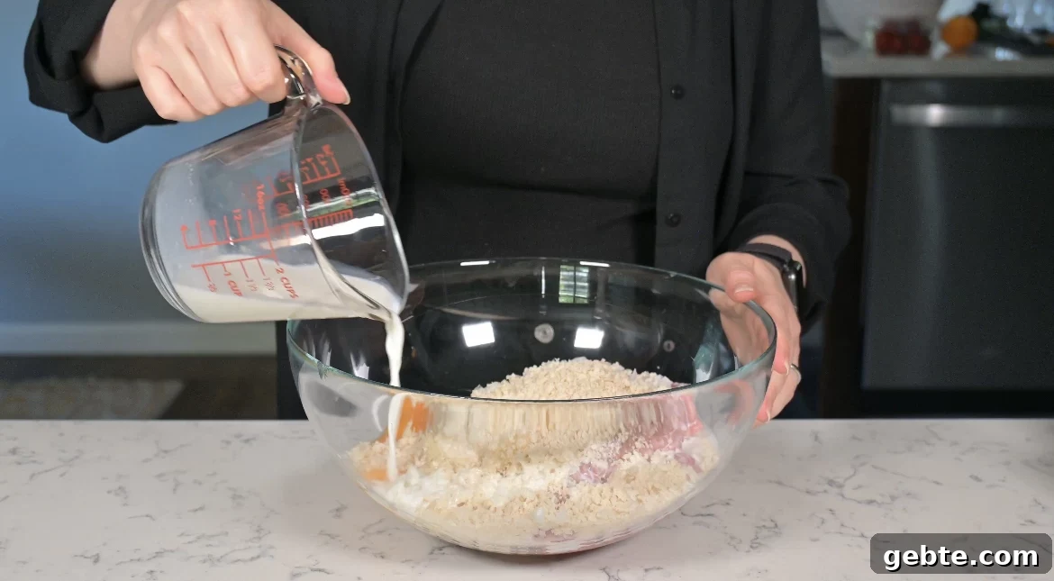Authentic Swedish Köttbullar Recipe: Classic Meatballs with Creamy Gravy 13 Adding ingredients to a bowl to make meatballs.