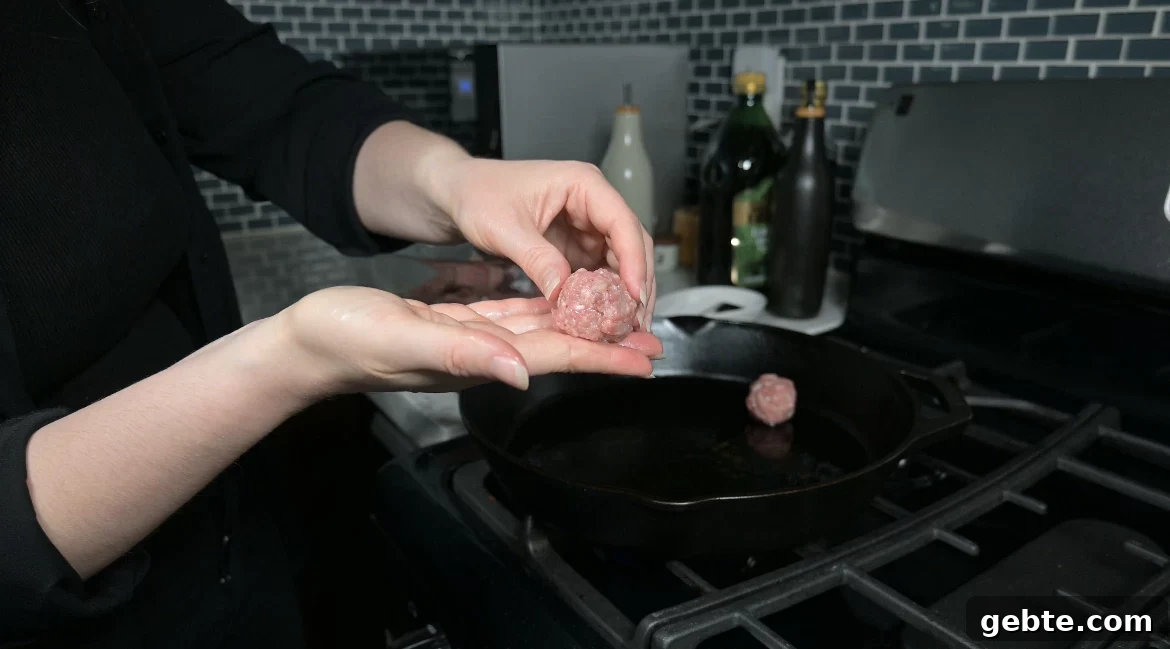 Authentic Swedish Köttbullar Recipe: Classic Meatballs with Creamy Gravy 15 Rolling meat mixture into meatballs.