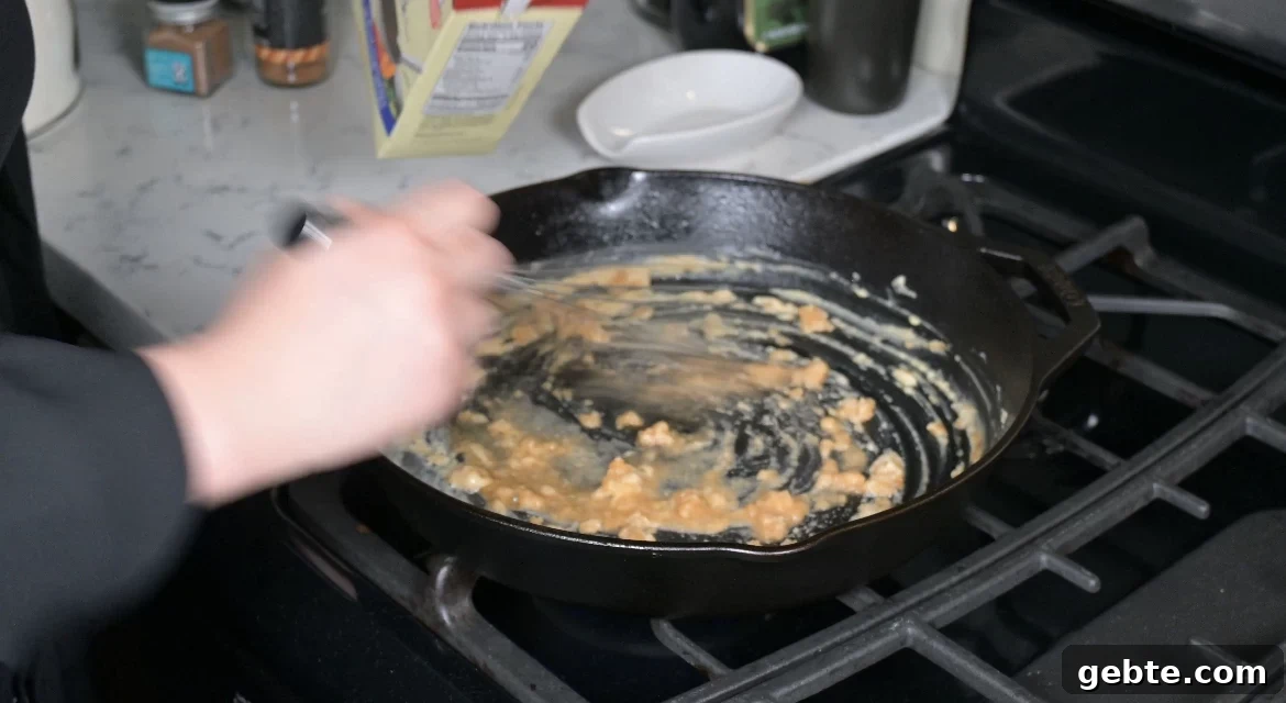 Authentic Swedish Köttbullar Recipe: Classic Meatballs with Creamy Gravy 19 Making gravy in a pan.