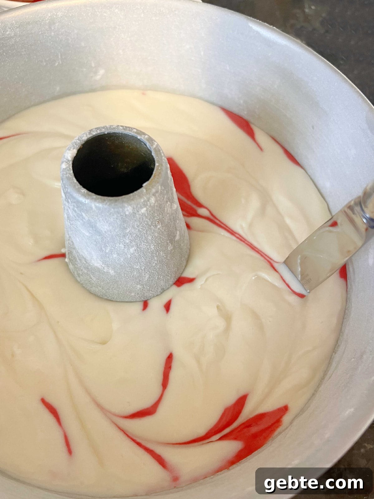 Marbling the cake batter in the pan with a knife.