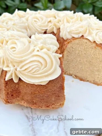 Eggnog pound cake, sliced, on a cake pedestal.