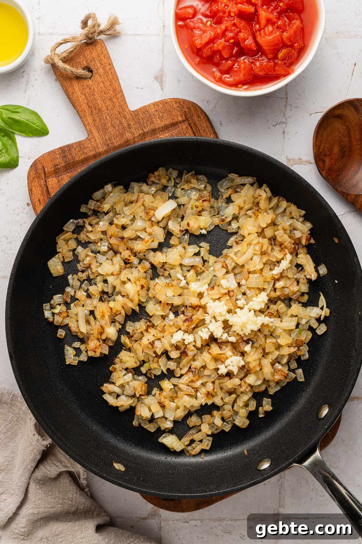 Creamy Vodka Penne with Grilled Chicken and Parmesan 7 Cooking onions and garlic in skillet.