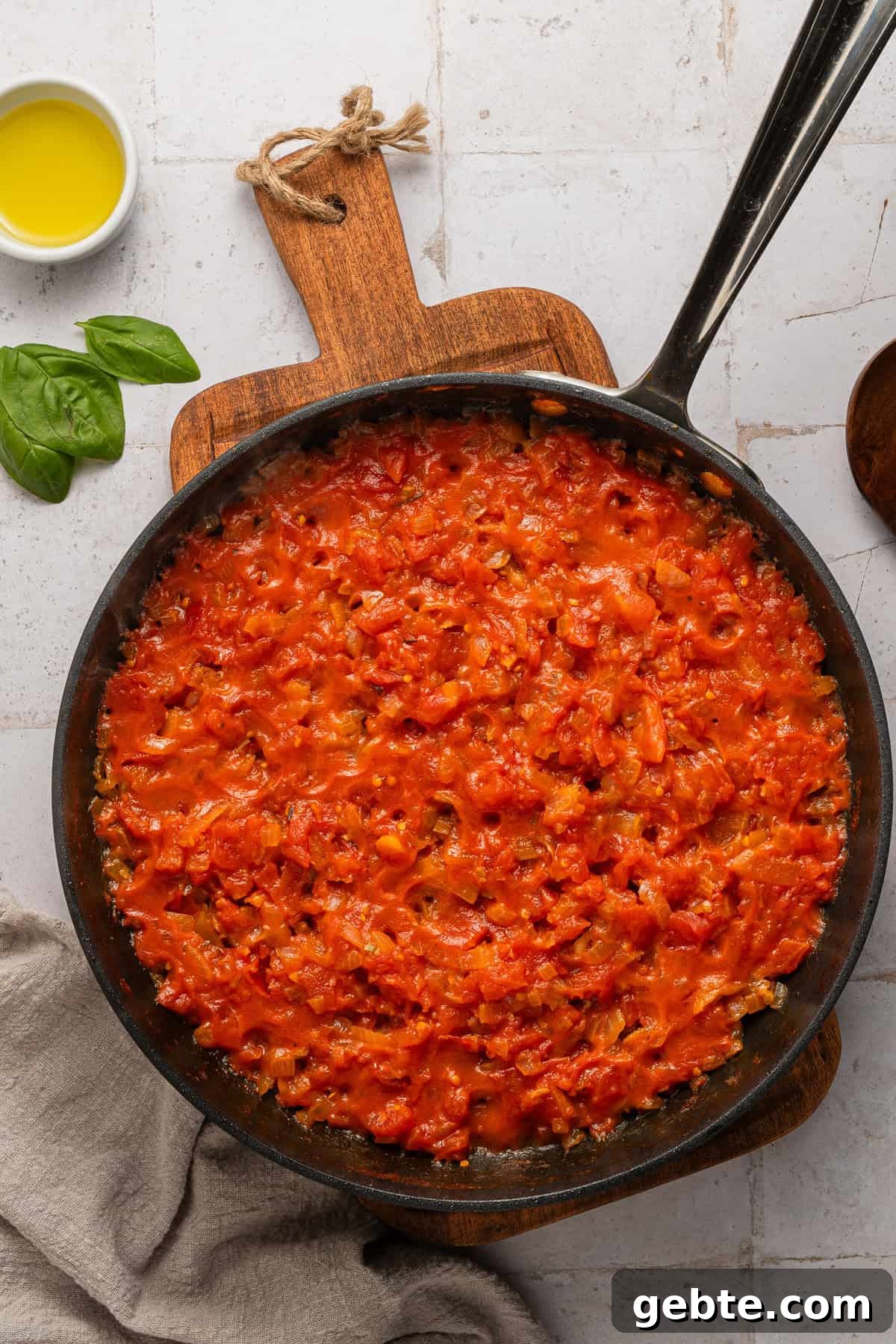 Creamy Vodka Penne with Grilled Chicken and Parmesan 8 Cooking tomato sauce in skillet.