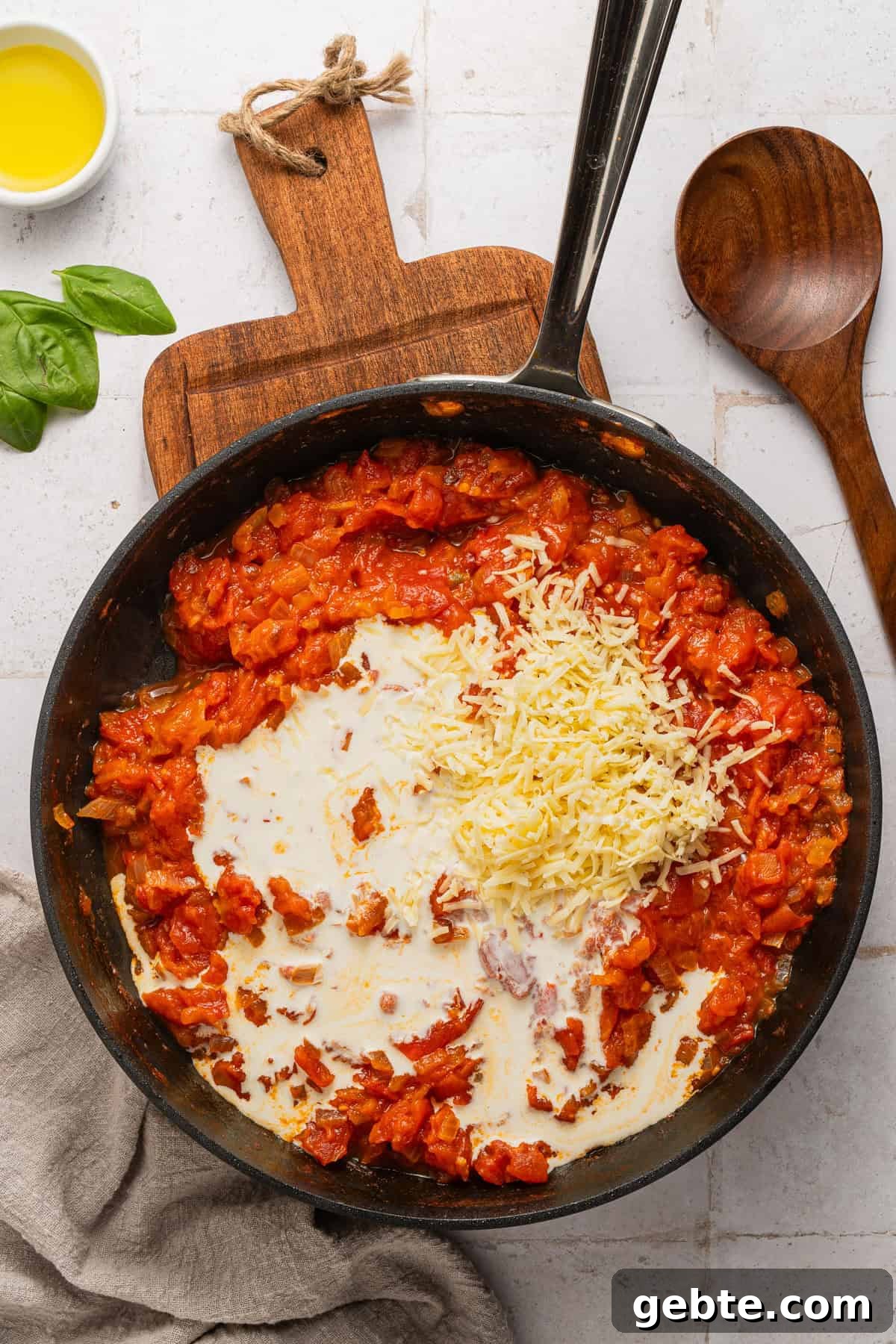 Creamy Vodka Penne with Grilled Chicken and Parmesan 9 Adding cream to the sauce.