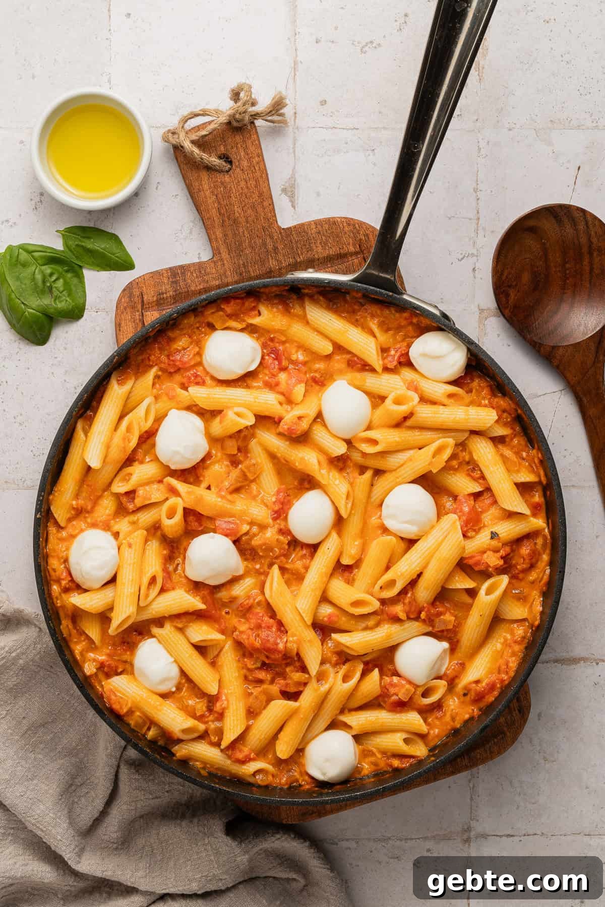 Creamy Vodka Penne with Grilled Chicken and Parmesan 10 Adding mozzarella balls the vodka sauce and pasta in the skillet.