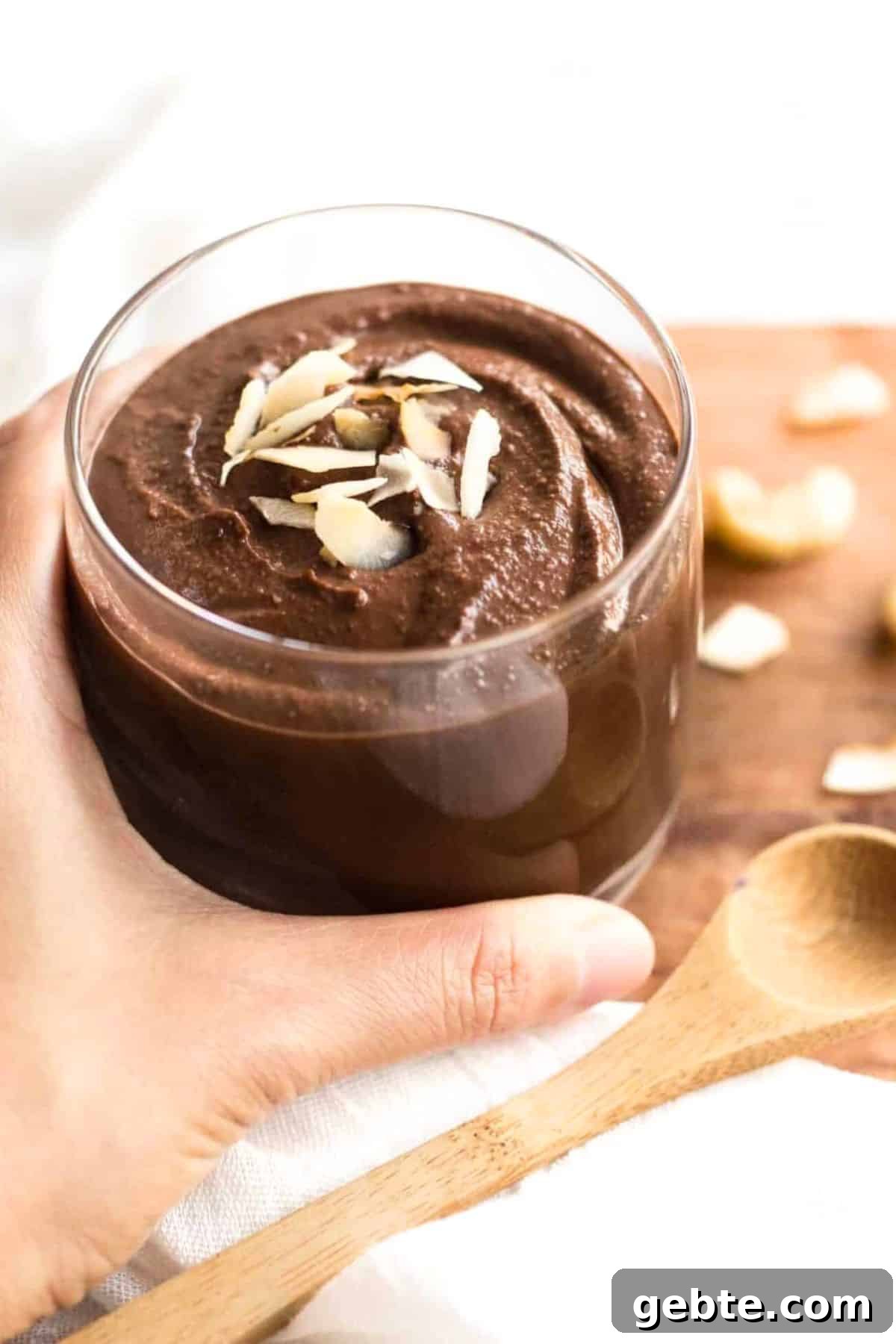 5-Minute Vegan Chocolate Pudding (Gluten-Free, Dairy-Free) Holding a glass of vegan chocolate pudding.