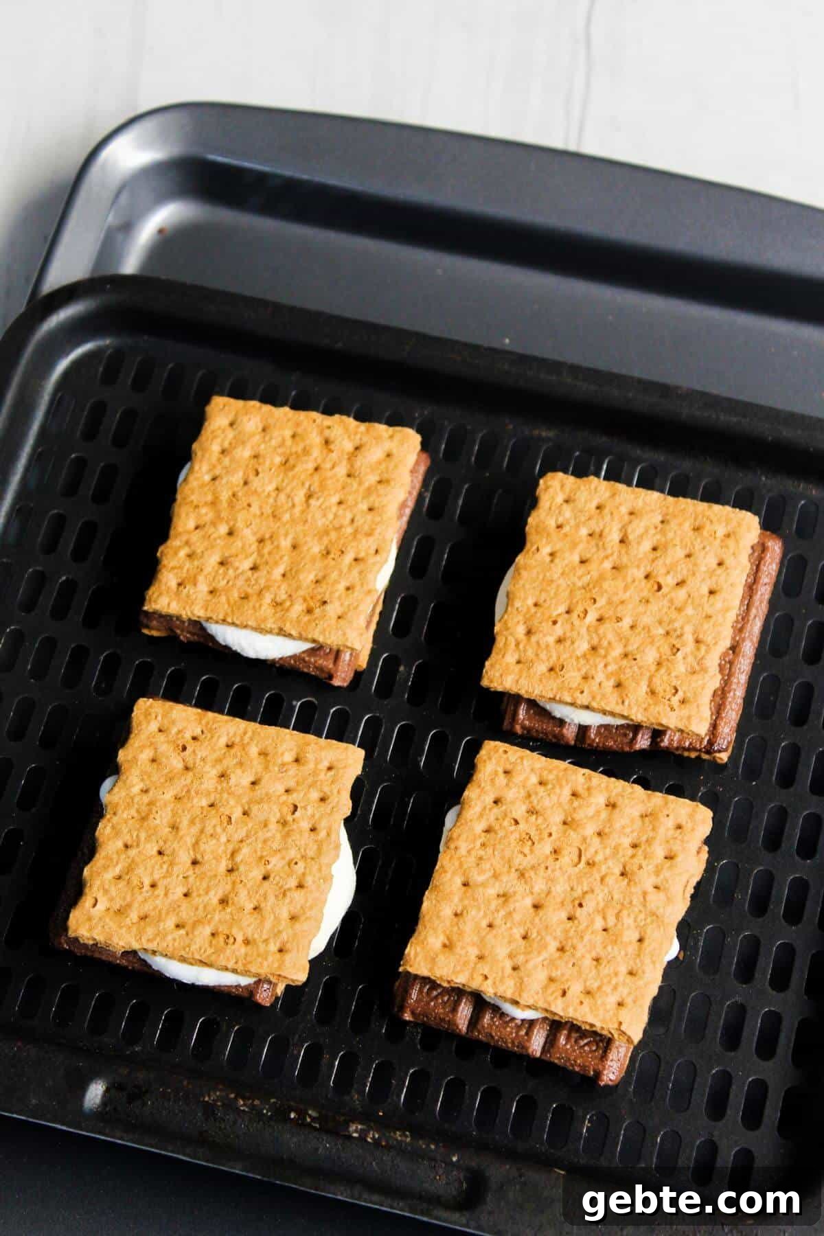 Crispy Air Fryer S'mores Recipe: Gooey Campfire Treats Fast 7 Graham cracker s'mores on air fryer tray.