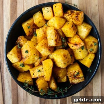 Roasted rutabaga cubes in a black bowl.