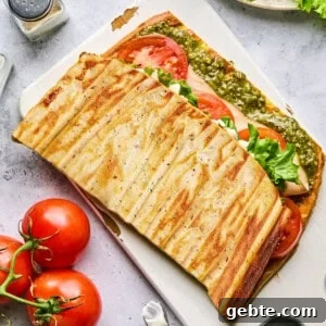 Protein-Packed Cottage Cheese Flatbread (Gluten-Free, Flourless) 14 cottage cheese flatbread stuffed with fillings on a cutting board