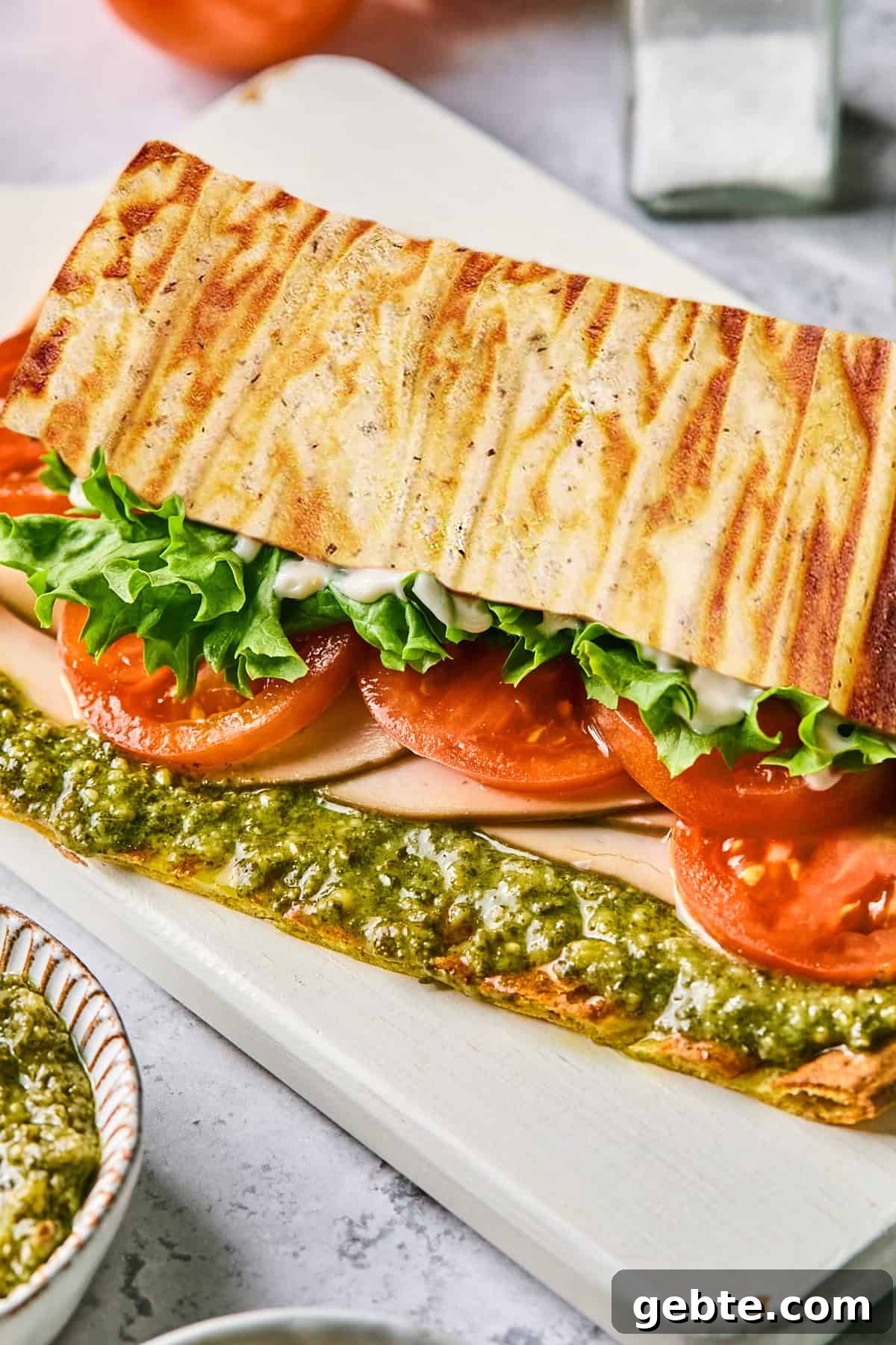 Protein-Packed Cottage Cheese Flatbread (Gluten-Free, Flourless) 9 a side view of a flatbread sandwich with lettuce, tomato, turkey and pesto