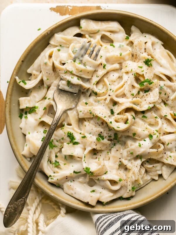 Protein-Packed Cottage Cheese Flatbread (Gluten-Free, Flourless) 10 tagliatelle pasta with alfredo sauce in a bowl with a fork topped with parsley
