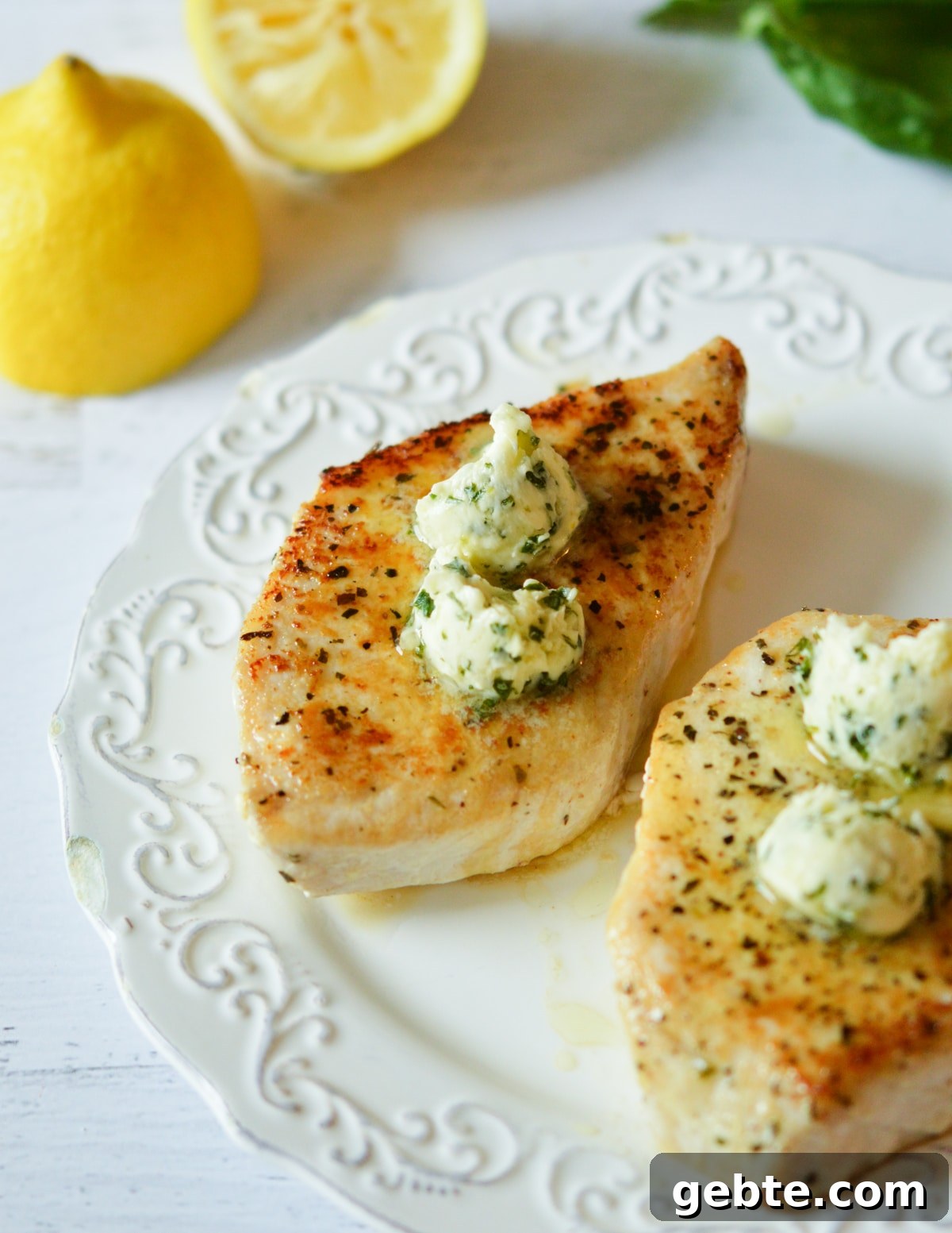 Lemon Basil Butter Baked Swordfish with Garlic and Herbs 7 swordfish fillets with lemon basil butter on top.