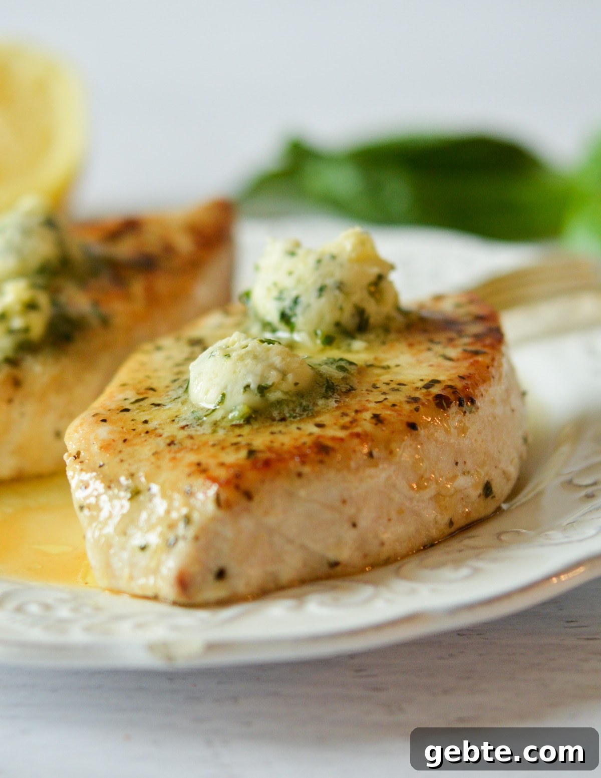 Lemon Basil Butter Baked Swordfish with Garlic and Herbs 8 cooked swordfish with lemon basil butter on top.