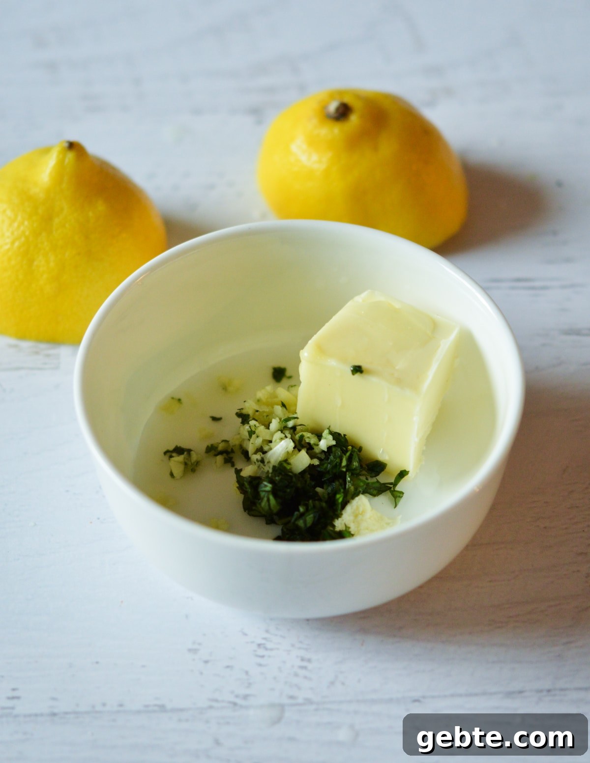 Lemon Basil Butter Baked Swordfish with Garlic and Herbs 4 a bowl of butter, basil, garlic, salt, and lemon juice.