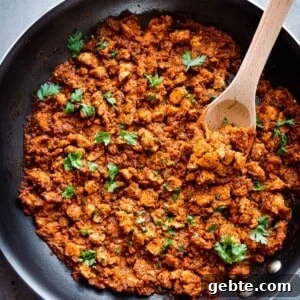 sofritas in a large pan with a wooden spoon.