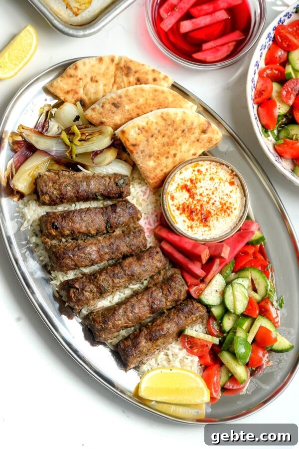 An easy to make Kabob Plate with ground beef and ground lamb skewers made in the oven, tomato salad, Syrian pickles with a tahini dipping sauce on the side.