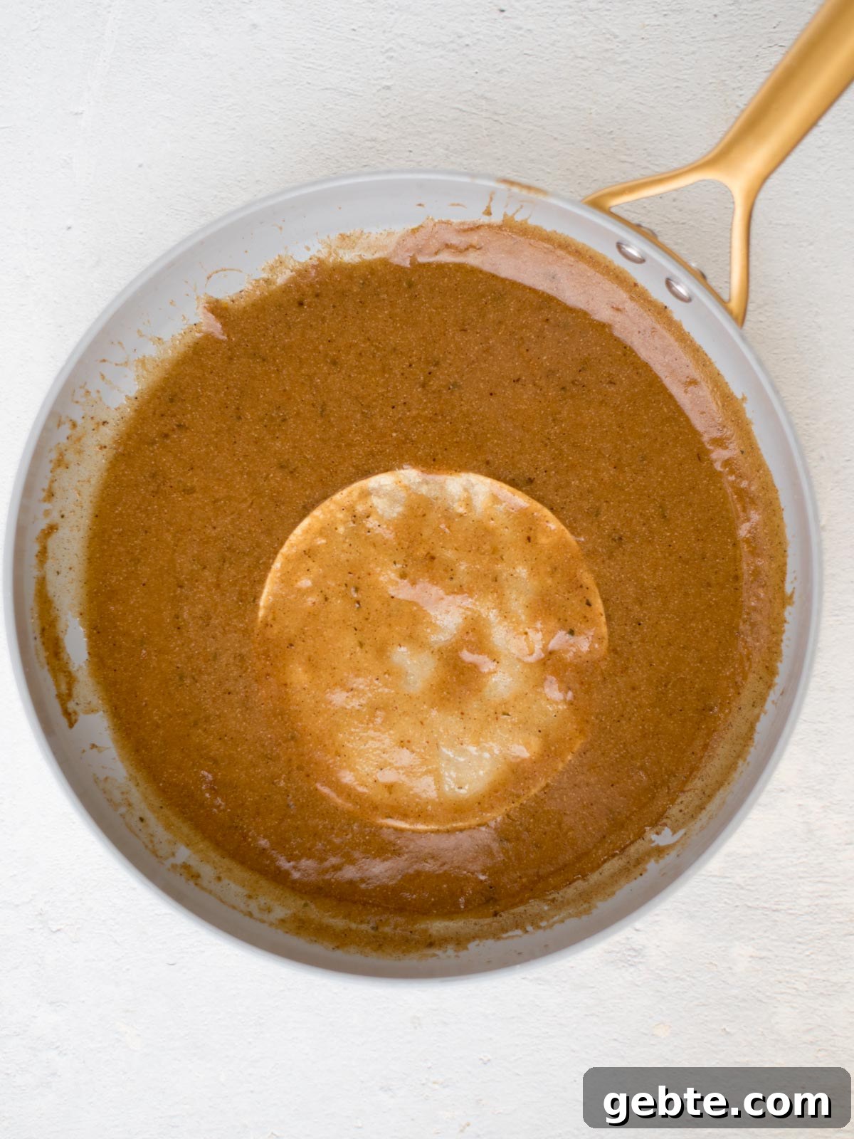 Authentic Red Chicken Enchiladas Recipe with Homemade Sauce 10 tortilla being coated in homemade enchilada sauce in a skillet