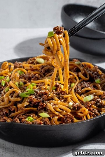 Top Pasta Recipes to Make Tonight 5 Mongolian ground beef noodles in a skillet with chopticks.
