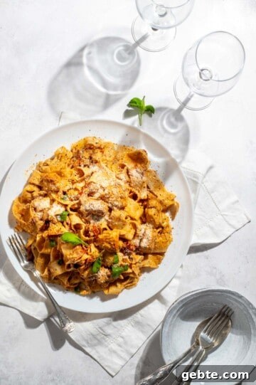 Top Pasta Recipes to Make Tonight 6 Marry me chicken pasta on a large white plate with two wine glasses.