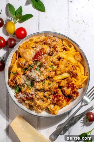Top Pasta Recipes to Make Tonight 8 Creamy chicken and chorizo pasta in a white bowl on a white washed background.