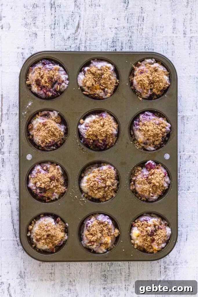 unbaked coffee cake muffins with peaches and blackberries