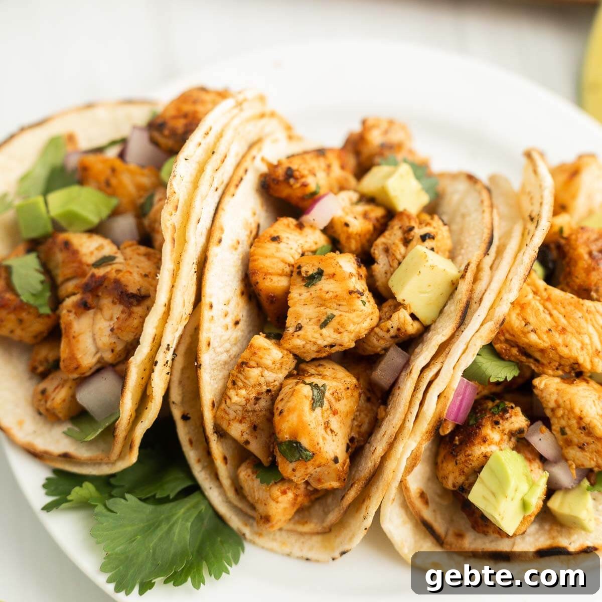 Crispy Blackstone Chicken Tacos with Charred Corn Salsa 8 Grilled chicken tacos with avocado and cilantro on soft flour tortillas.