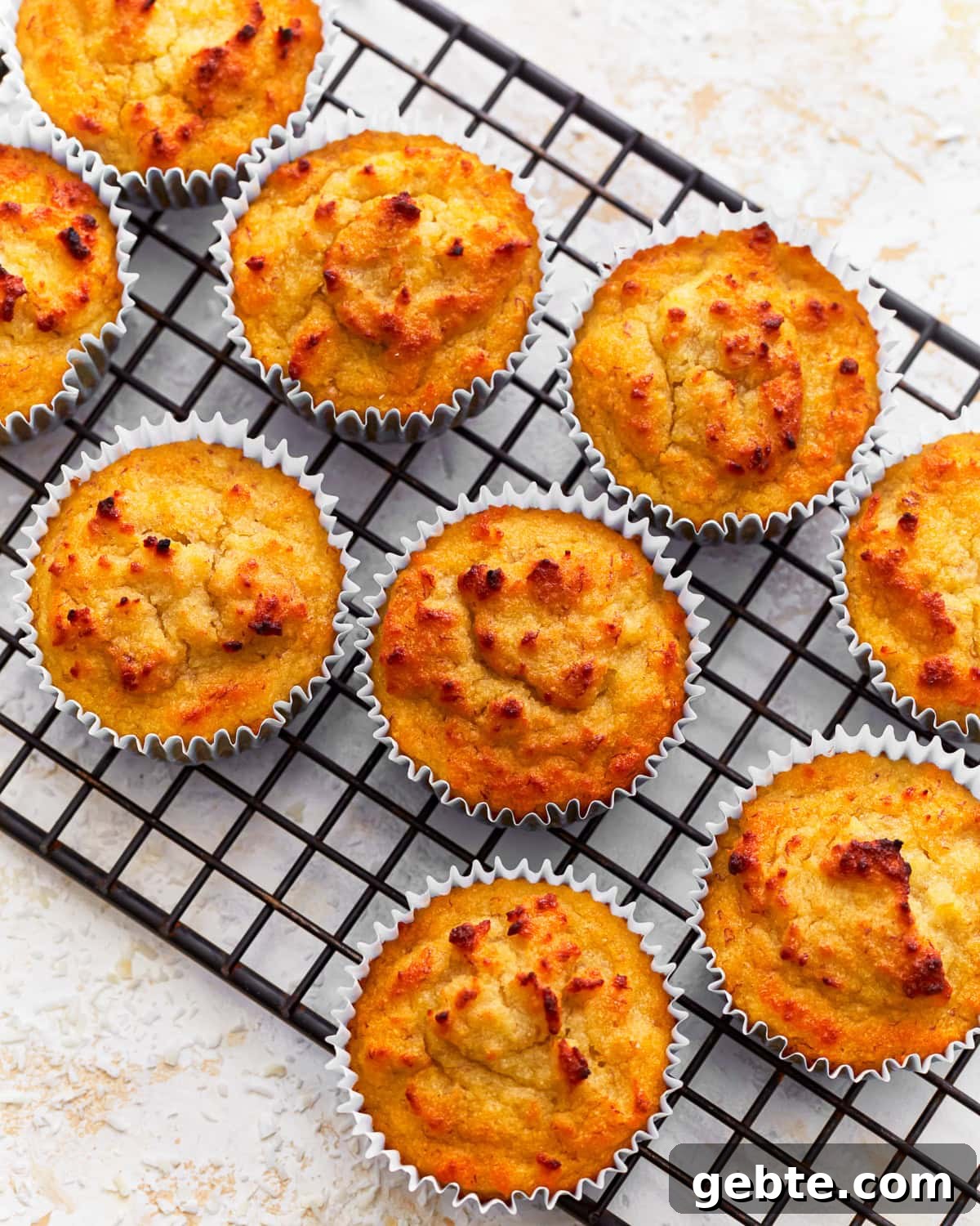 Overhead view of coconut flour muffins on a cooling rack.