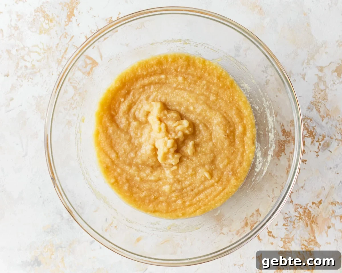 Batter for coconut flour muffins in a glass mixing bowl.