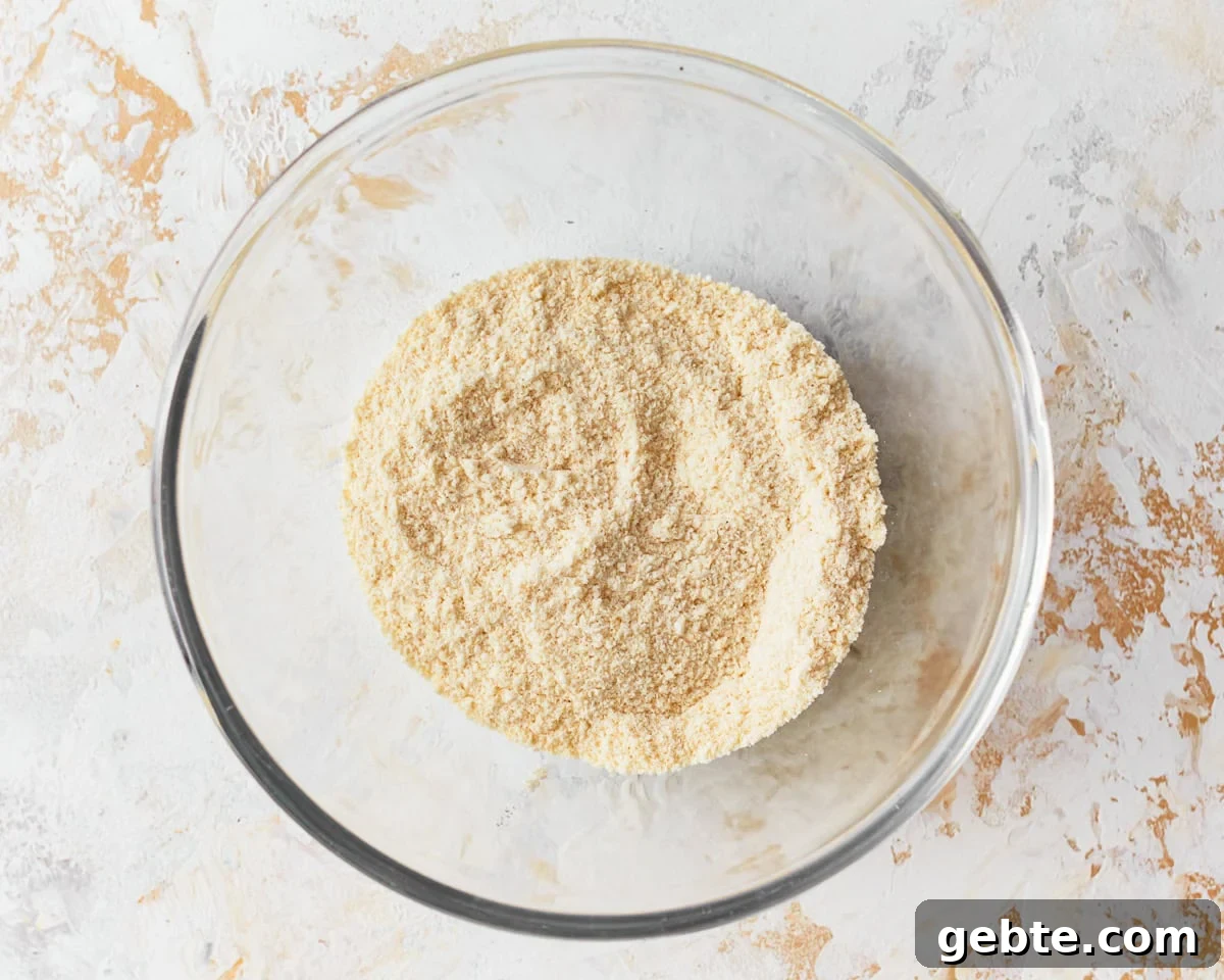 Dry ingredients for coconut flour muffins in a glass mixing bowl.