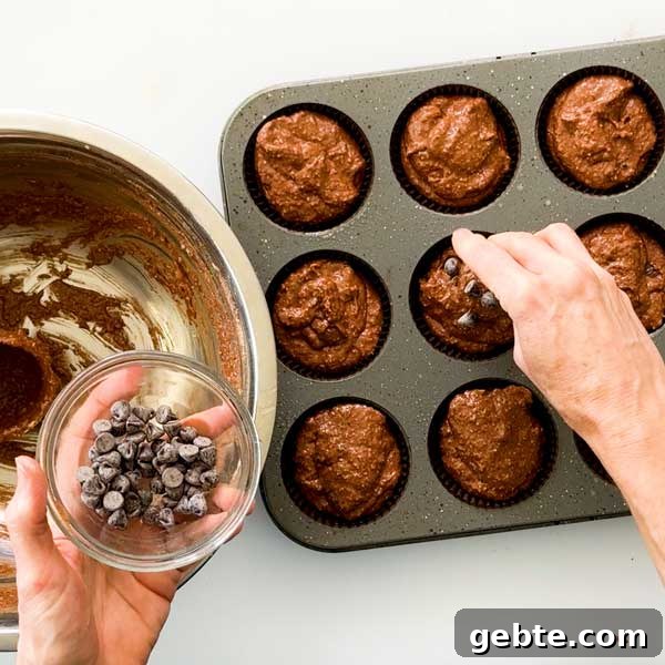 Chocolate Banana Protein Muffins with Oat Flour Recipe 6 Adding chocolate chips to the tops of the muffins.