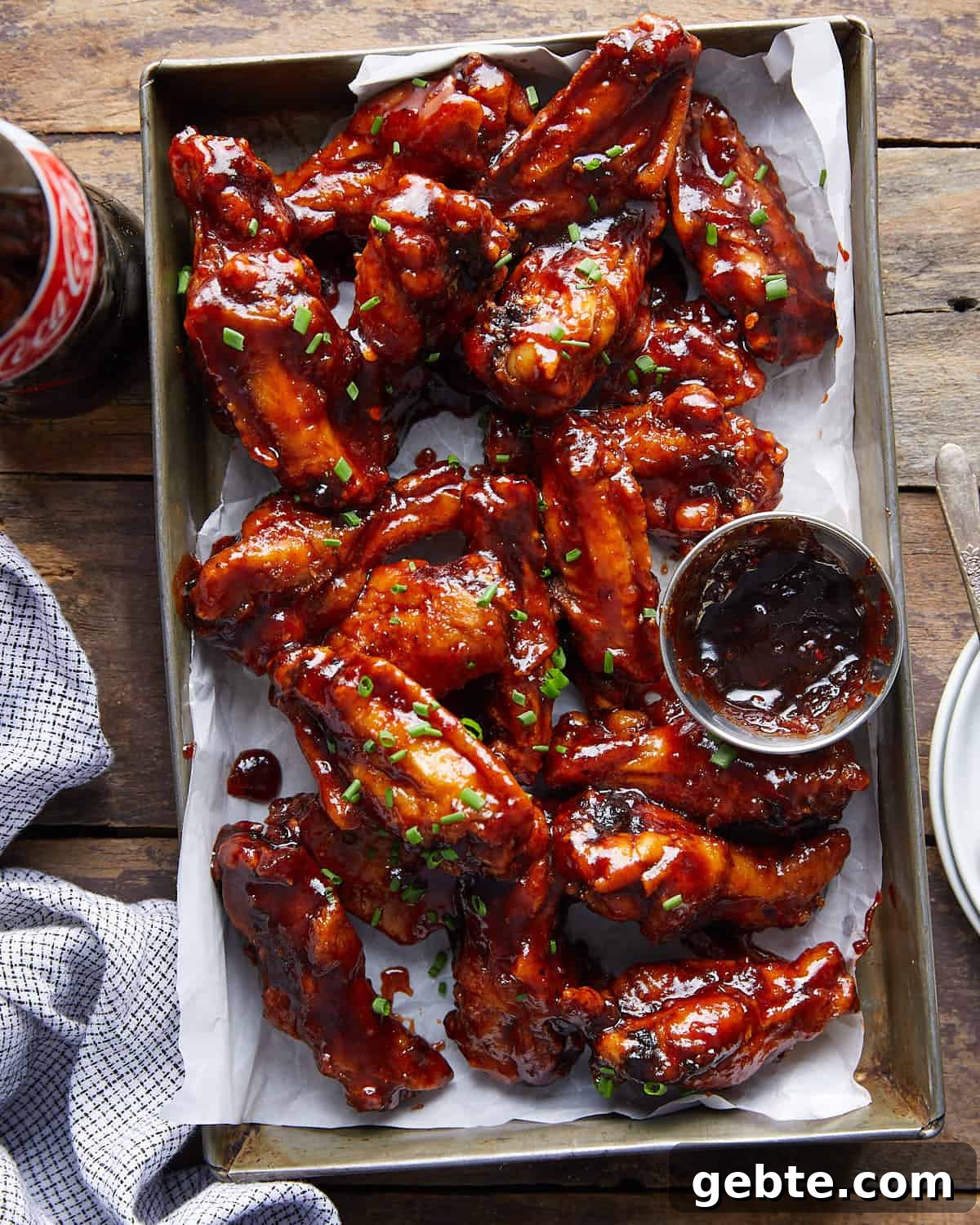 Overhead image of sticky bbq chicken wings with garnish.