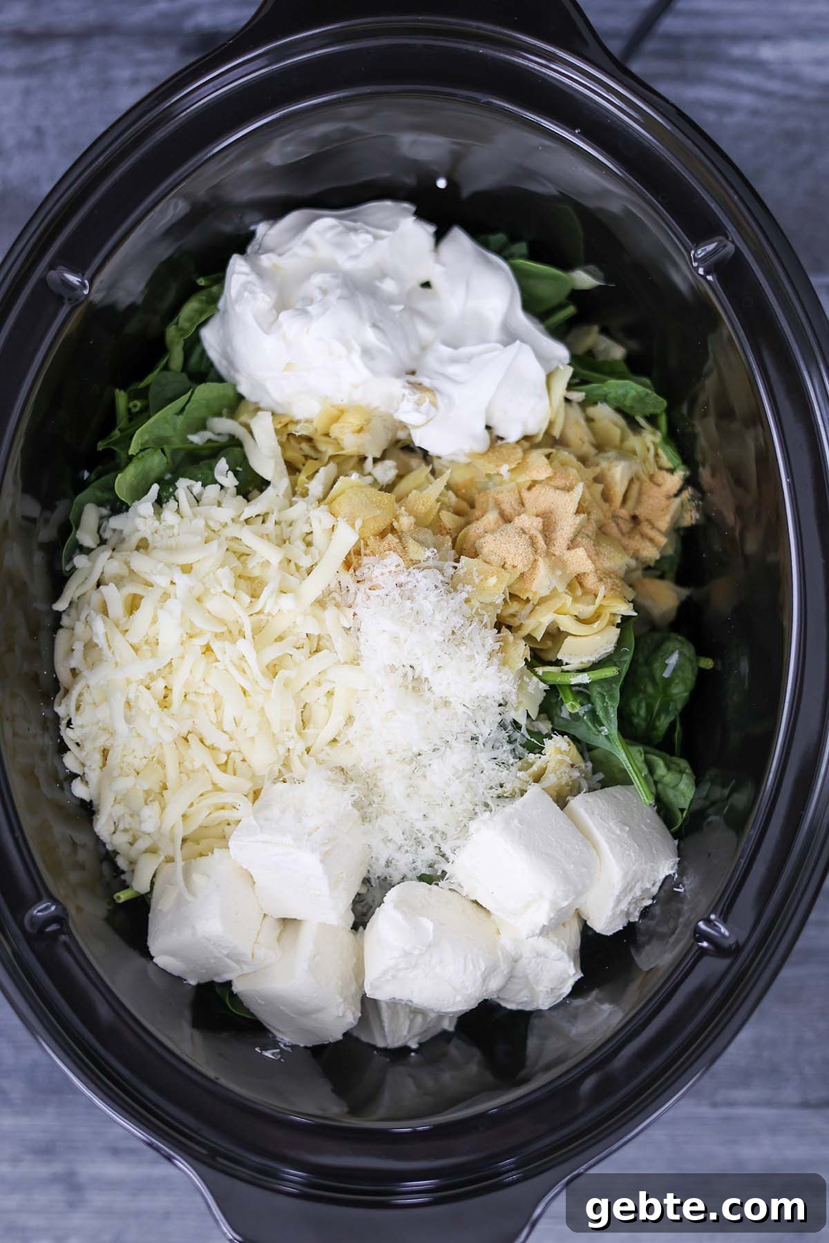 Slow Cooker Spinach and Artichoke Dip Recipe for Parties 4 Ingredients in the crockpot.