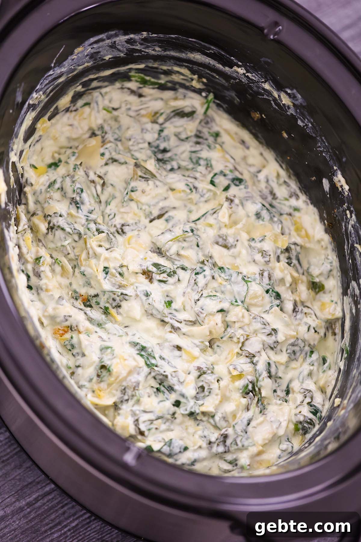 Slow Cooker Spinach and Artichoke Dip Recipe for Parties 5 spinach artichoke dip in the slow cooker.